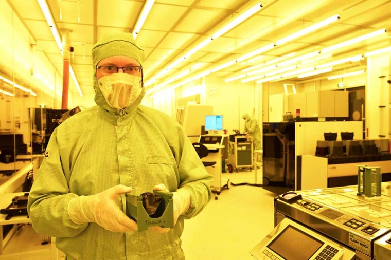 Smart Photonics CTO Luc Augustin holding a wafer that contains photonic chips...