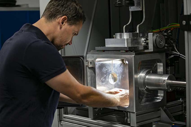 A LaVa-X employee works on a laser welding machine with the open evacuation...