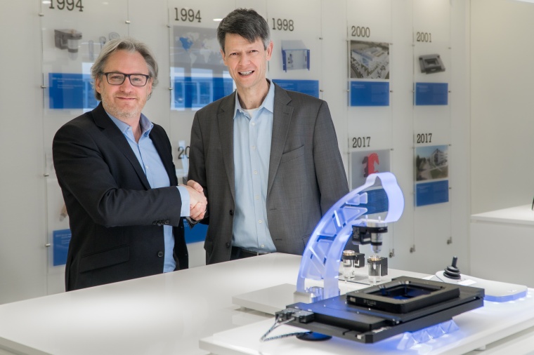 Stéphane Bussa, Vice President of Sales & Marketing, congratulates Dr. Thomas...