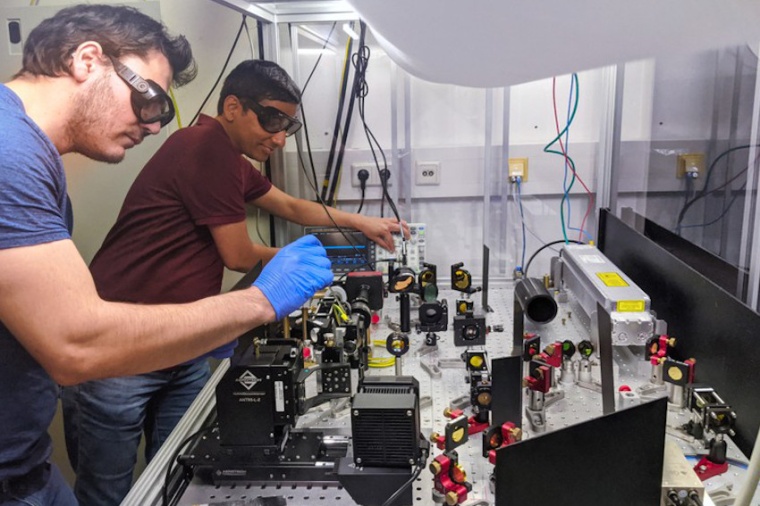 Carlos Saavedra (l.) and Deepak Pandey prepare the optical microfilter for test...