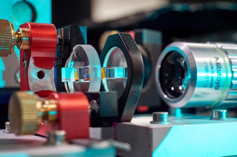 On the right is a microscope objective used to observe and analyze the light...