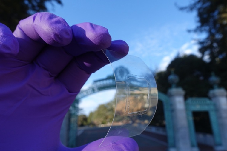 Applying mechanical strain on this atomically thin, transparent monolayer...