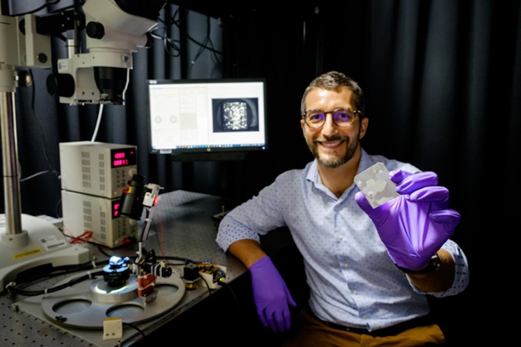 NTU researcher Matteo Seita holding a piece of 3D-printed metal alloy, which...