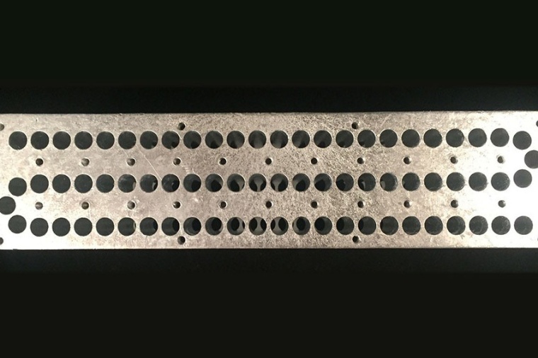 The quantum flute: The holes create different wavelengths, akin to notes on a...