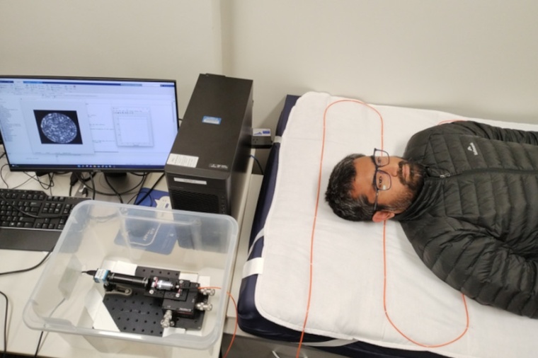 Tiny optical fiber sensors are attached to the upper surface of a hospital...