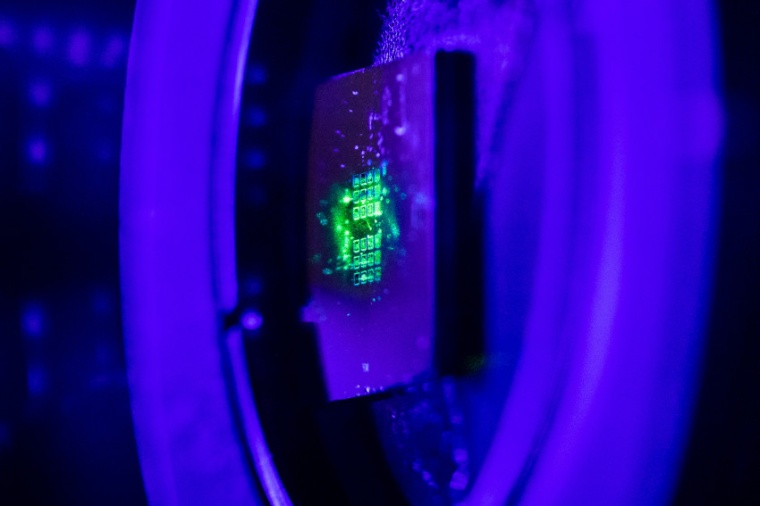 Green laser light illuminates a very thin metasurface to produce entangled...