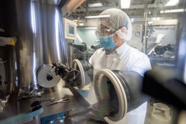 Researcher Bin Liu is shown in the lab loading a patterned dielectric sample...