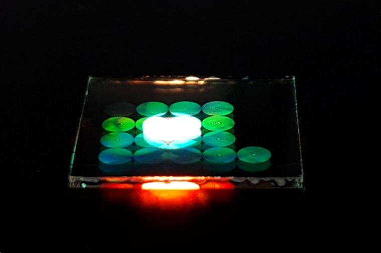 Several metalenses on a glass substrate, illuminated from the top with white...