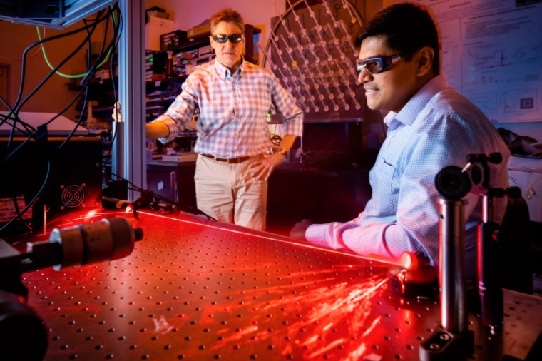 Prasad Iyer (r.) and Igal Brener demonstrate the optical hardware used for beam...