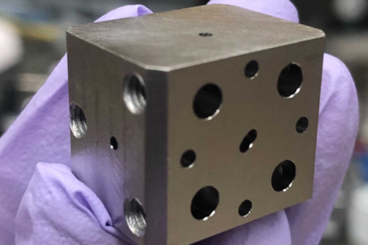 A niobium super­conducting cavity. The holes lead to tunnels which intersect...