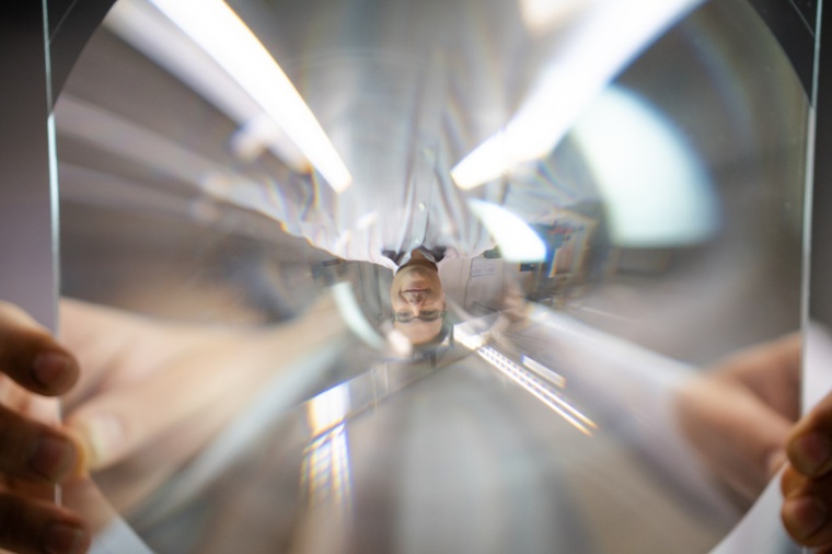 Researcher Michal Karpinski with a standard Fresnel lens. (Source: M....