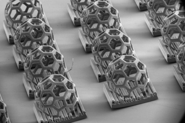 The 3D-printed lab logo, featuring a buckyball geometry, demonstrates the...