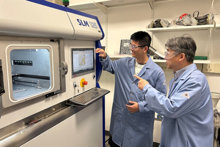 Xinghang Zhang (r.) and Anyu Shang prepare to use a 3D printer at the Flex Lab...