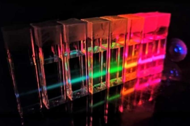 Cadmium telluride quantum dots of different sizes emitting light in response to...