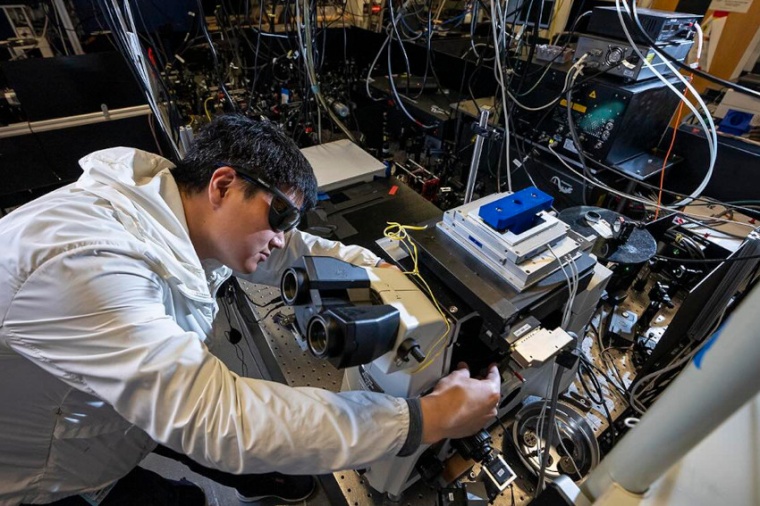 Xiao Qi in the laser room at the Molecular Foundry. Qi used the setup to...